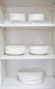 a white cabinet with white plates and bowls at 3 Bed Pet Friendly Home, With BBQ in Dartford +66 photos