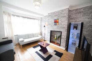 a living room with a couch and a fireplace at 3 Bed Pet Friendly Home, With BBQ in Dartford