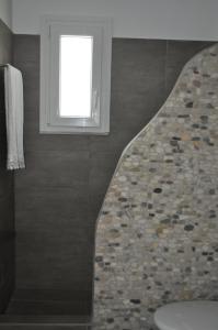 a bathroom with a toilet and a window at Fairytale View in Karistos +35 photos