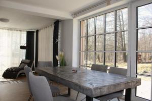 a dining room with a large stone table and chairs at Apartmán Lesněnka in Říčky