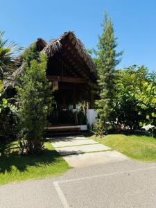 a house with a tree in front of it at Experience Coconut Paradise Apart O2 in San Cristóbal +19 photos