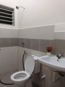 a bathroom with a toilet and a sink at Homestay Ismail LEKIR in Sitiawan