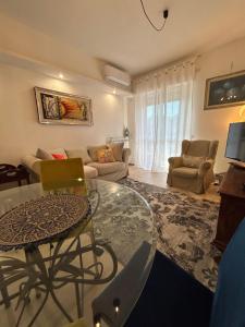 a living room with a table and a couch at Lakehouse Enjoy in Verbania