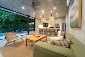 a living room with a couch and a table at Manuel Antonio Tree House Villas in Quepos