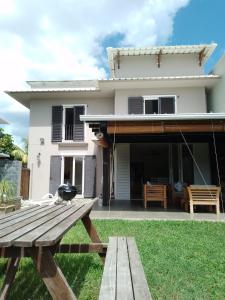 a house with a picnic table in front of it at Villa Rea at Tamarin Beach in Tamarin
