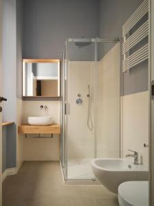 a bathroom with a glass shower and a sink at Antico Palazzo Giugni - Adults Only - in Florence
