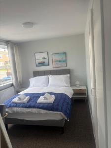 a bedroom with a bed with two towels on it at Blencathra in Penrith