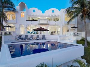 a large white building with a swimming pool in front of it at 3067 - Casa Blanca in Tangolunda