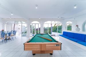 a pool table in a room with a blue couch at 3067 - Casa Blanca in Tangolunda