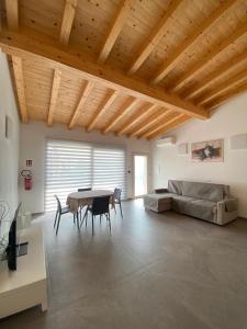 a living room with a table and a couch at Chalet Marghe 1 in Rovetta