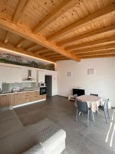 a kitchen and dining room with a table and chairs at Chalet Marghe 1 in Rovetta