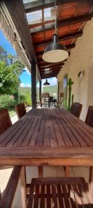 a wooden table with chairs on a patio at Les Hauts de Cabanoule - Tornac - Générargues in Générargues