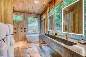 a bathroom with a tub and a sink at Greenridge- Upscale Architecture and Modern Design in Blue Ridge