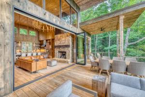 an open living room with a fireplace in a forest at Greenridge- Upscale Architecture and Modern Design in Blue Ridge