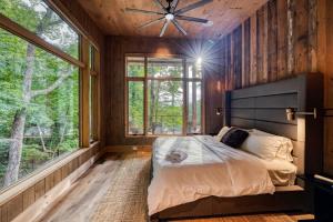 a bedroom with a bed and a large window at Greenridge- Upscale Architecture and Modern Design in Blue Ridge