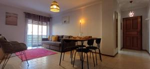 a living room with a table and a couch at Casa da Praia - Beach of Sand and Sea at the Door in Vila Praia de Âncora