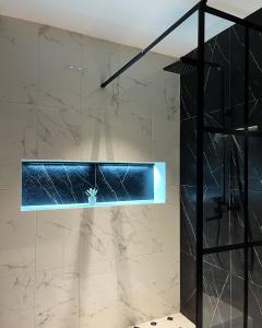 a bathroom with a shower with a glass wall at Ateni Hills in Gori +43 photos