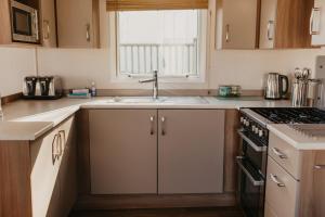 a kitchen with a sink and a stove at Lower Cliff 9 in Portland