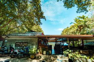 a building with motorcycles parked in front of it at Taatoh Seaview Resort - SHA Plus in Koh Tao