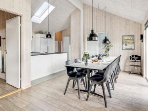 a kitchen and dining room with a table and chairs at 5 star holiday home in Idestrup in Bøtø By