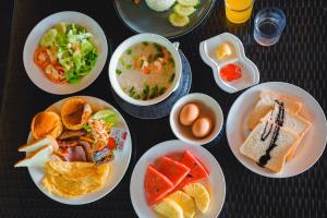 a table with plates of food and bowls of food at Taatoh Seaview Resort - SHA Plus in Koh Tao