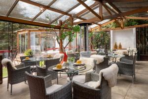 an outdoor dining area with tables and chairs at Pousada Apple House Campos do Jordao in Campos do Jordão