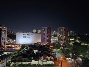 a large billboard in a city at night at Apartamento confortável in Manaus