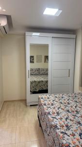 a bedroom with a bed and a dresser and a closet at Apartamento confortável in Manaus +18 photos