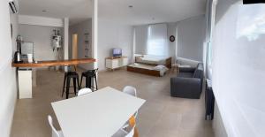 a living room with a table and a couch at alquiler diario el palmar in Cinco Saltos