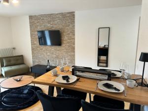 a dining room with a table and chairs and a television at Studio Chesery in Morgins