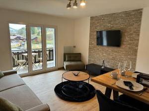 a living room with a couch and a table at Studio Chesery in Morgins