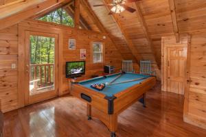 a pool table in a room in a cabin at Dreams Do Come True by American Patriot Getaways in Cartertown