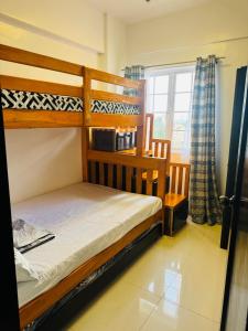 バギオにある2BR with Veranda, Unli Netflix, Wifiの二段ベッド2台と窓のある寝室