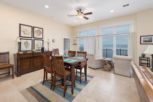 a dining room with a table and a couch at Sea Point #306 in Saint Simons Island