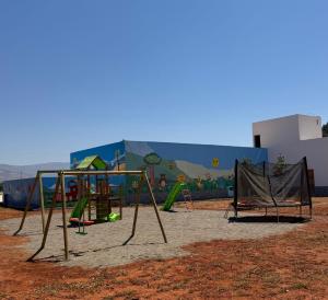 a playground in front of a building with a mural at Mini Villa alhoceima in El Arba de Trougout