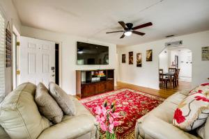 a living room with a couch and a ceiling fan at Walkable to FSU Campus Cozy Retreat with Deck! in Tallahassee