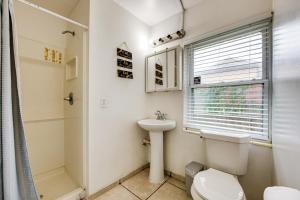 a bathroom with a toilet and a sink at Walkable to FSU Campus Cozy Retreat with Deck! in Tallahassee +16 photos