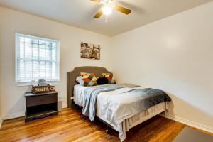 a bedroom with a bed and a ceiling fan at Walkable to FSU Campus Cozy Retreat with Deck! in Tallahassee