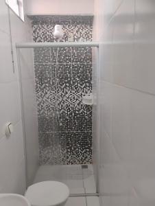 a white bathroom with a shower with a toilet at Pousada San Valen in Aparecida +95 photos