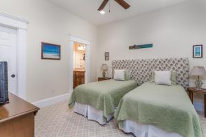 a bedroom with two beds and a television at Sea Point #304 in Saint Simons Island +17 photos