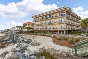 a building on the beach next to a beach at Sea Point #304 in Saint Simons Island
