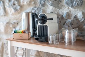 a coffee maker sitting on top of a counter at Château De La Rive in Cruet +46 photos