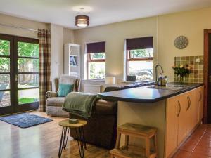 a kitchen and living room with a sink and a couch at Lime Tree Cottage in Drumpark +19 photos