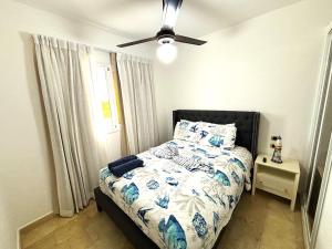 a bedroom with a bed and a ceiling fan at Exclusive Punta Cana Apartment - Private Jacuzzi in Punta Cana