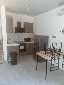 a kitchen with chairs and a table and a sink at Maison Saint-Dizier in Saint-Dizier