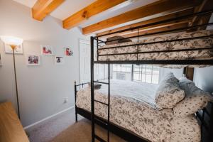 a bedroom with a bunk bed in a room at Cozy Condo, Minutes from Sunday River in Bethel
