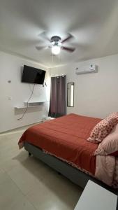 a bedroom with a bed and a ceiling fan at Casa Moderna en Fraccionamiento in Caucel