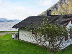 a building next to a body of water at 7 person holiday home in Selje in Selje