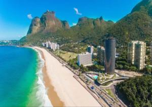a view of a beach with buildings and the ocean at Hotel Nacional Rio de Janeiro in Rio de Janeiro