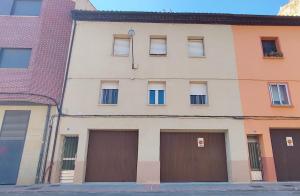 a building with three garages and two garage doors at La Casa de la Calzada in Santo Domingo de la Calzada